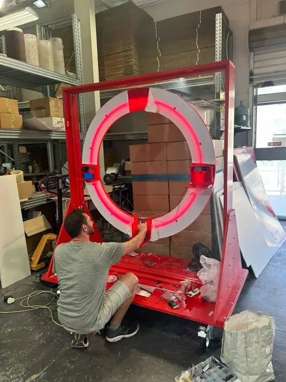 Engineer assembling a large custom hardware prototype in the fabrication lab