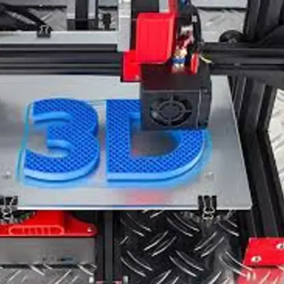 FDM 3D printer mid-print of a blue '3D' lettering on the build plate